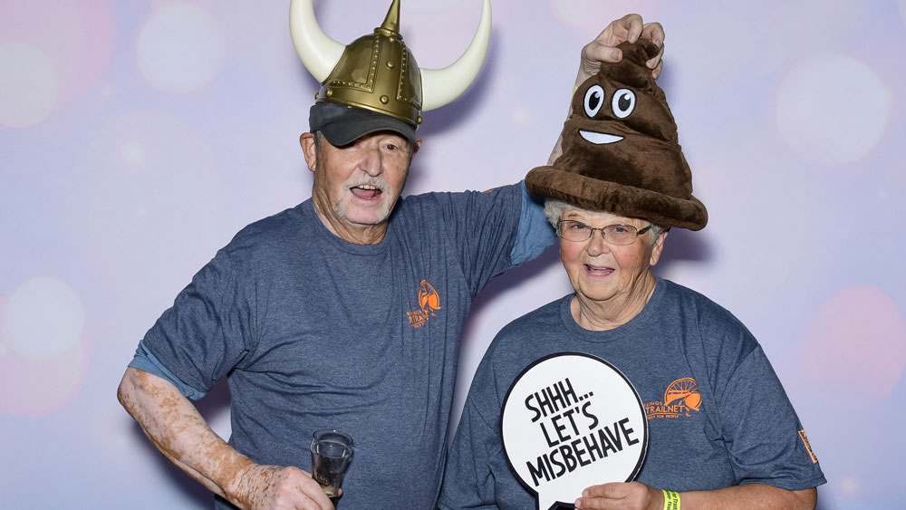 Cute older couple having fun in the photo booth props